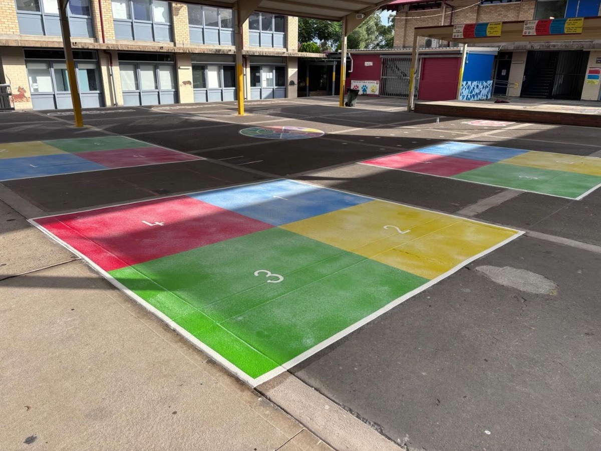 Students using thermoplastic playground markings at an Australian primary school